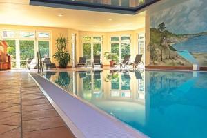 a large swimming pool in a large house at Seepark Heidenholz, Plau am See in Plau am See +26 photos