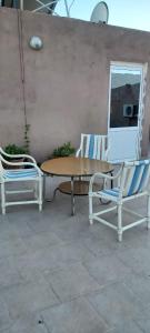 two chairs and a table and a table and chairs at Hôtel Titrit in Tafraout