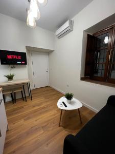 a living room with a couch and a table at Apartamentos Rey in Córdoba