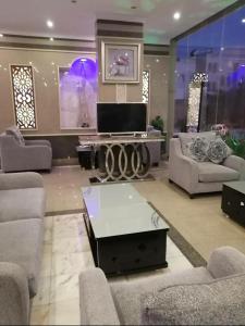 a large living room with couches and a tv at Golden New Al Dar - جولدن نيو الدار in Jazan