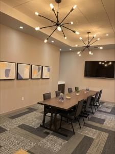 a conference room with a long table and chairs at Cambria Hotel Minneapolis Downtown in Minneapolis