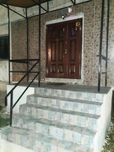 a set of stairs in front of a door at Apartament Lupeni in Lupeni +1 photo