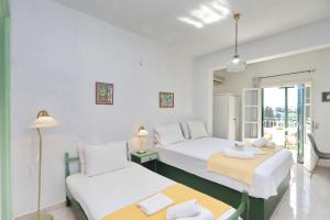 a bedroom with two beds and a table at Pelagos in Stafylos