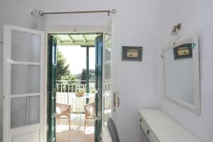 a bathroom with a door open to a patio at Pelagos in Stafylos