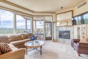 a living room with a couch and a fireplace at River Ridge 332AB in Bend