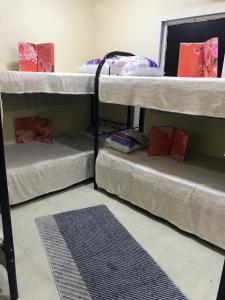 3 literas en una habitación con alfombra en Guest House en Dubái