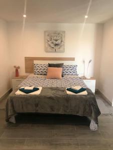a bedroom with a large bed with two pillows at Casa Alegria in Antas