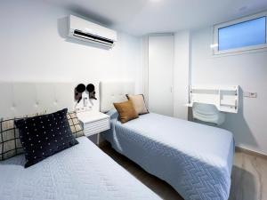 a small bedroom with a bed and a toilet at El Dorado 114 luxury with full air-conditioning in Playa de las Americas