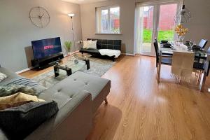 a living room with a couch and a table at Modern 3BR House For Contractors in Stockingford