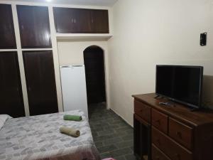 a bedroom with a bed and a flat screen tv at POUSADA VISTA CHINESA in Rio de Janeiro