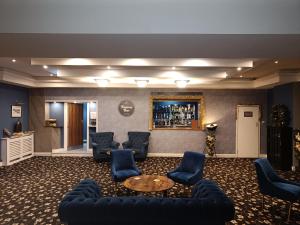 a room with couches and a table and a bar at Torbay Court Hotel in Paignton