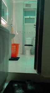 a bathroom with a toilet and a sink at Comfy Apartment with private yard in 6 October city Cairo in 6th Of October +10 photos