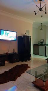 a living room with a flat screen tv on the wall at Comfy Apartment with private yard in 6 October city Cairo in 6th Of October