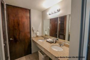 a bathroom with two sinks and a large mirror at Costa Bonita Private Villa 602 in Culebra