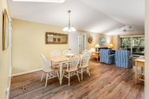 a dining room and living room with a table and chairs at Summerwind Cottage 1157 in Seabrook Island