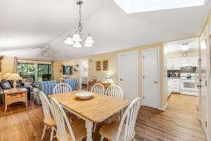 a dining room and living room with a table and chairs at Summerwind Cottage 1157 in Seabrook Island