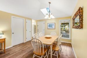 a dining room with a wooden table and chairs at Summerwind Cottage 1157 in Seabrook Island