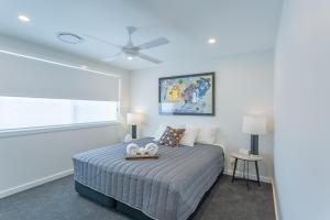 a bedroom with a bed and a large window at Chapel Heights Apartments in New Lambton