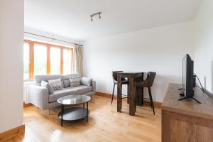 a living room with a couch and a table at Belarmine in Stepaside