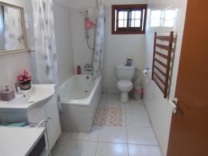 y baño con bañera, aseo y lavamanos. en Kampi Double Storey House in the Village, en Nicosia