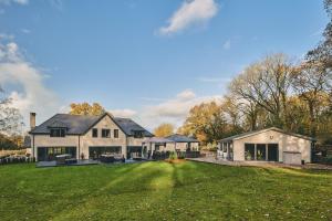 a large white house with a large yard at Woodland House in Belbroughton