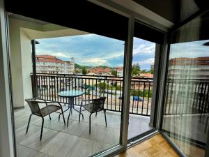 a balcony with a table and chairs and a view at Premium Apartments in Gjakove