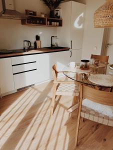 a kitchen with a table and a dining room at Breeze Albatross in Ķesterciems +11 photos