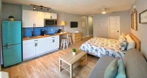 a kitchen and a bedroom with a bed and a couch at Sea Dip Resort Studios! in Daytona Beach