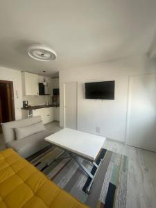 a living room with a couch and a table at Renovated modern apartment in the city center in Santa Cruz de Tenerife