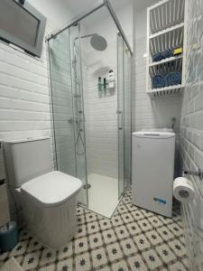 a bathroom with a toilet and a glass shower at Renovated modern apartment in the city center in Santa Cruz de Tenerife
