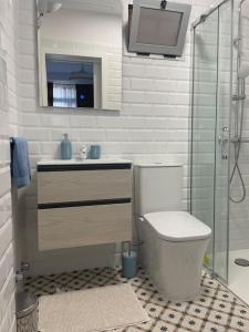 a bathroom with a toilet and a sink and a shower at Renovated modern apartment in the city center in Santa Cruz de Tenerife