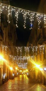 a string of lights hanging over a street at night at MEMA HOLIDAY HOME in Aosta