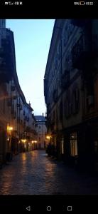 an empty street in a city with buildings at MEMA HOLIDAY HOME in Aosta