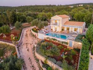 an aerial view of a house with a swimming pool at Fiscardo Luxury Stone Villa Suzana ,with sunset view! in Fiskardo