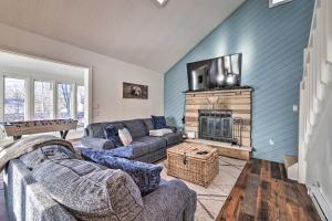 a living room with a couch and a fireplace at Cozy Tobyhanna Cottage with Private Hot Tub! in Tobyhanna