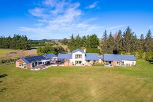 an aerial view of a house with a large yard at The Meadows Villa in Christchurch