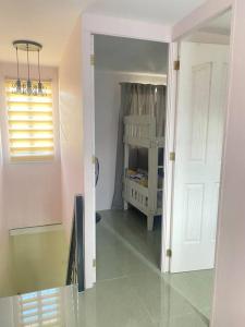 a hallway with a door to a room with a crib at 2 Bedroom townhouse in Bacolod City in Bacolod