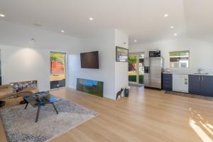 a living room with a couch and a table at The Meadows Villa in Christchurch