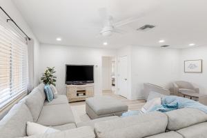 a living room with a couch and a tv at Paradise Found in Clearwater Beach