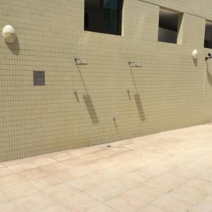 Una pared de ladrillo con cuatro duchas. en Lindo apartamento no bairro de Manaira, en João Pessoa