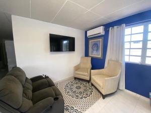 a living room with a couch and two chairs at Centric 3B/1Bath near trendy Loiza Street in San Juan