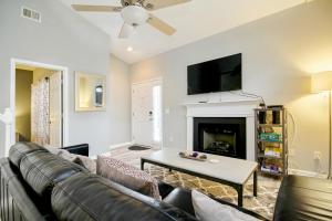 a living room with a couch and a fireplace at Fairway Oaks Getaway in Myrtle Beach