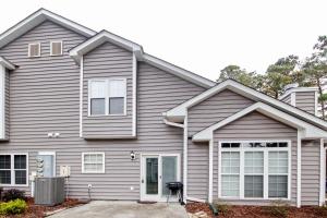 a house with grey siding at Fairway Oaks Getaway in Myrtle Beach