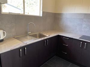 a kitchen with a sink and a counter top at Blue Seas Motel in Kaikoura