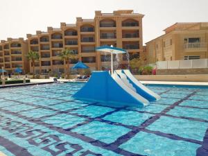 a slide in the swimming pool at a resort at Red Sea Panorama in Hurghada