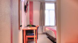 Letto o letti in una camera di Hotel Le Terminus