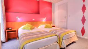 Letto o letti in una camera di Hotel Le Terminus