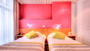 Letto o letti in una camera di Hotel Le Terminus