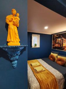 a bedroom with a statue of two people on a bed at Sto Antonio Guest House in Lisbon