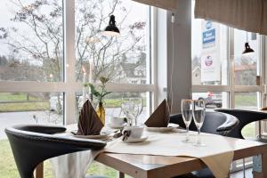 uma mesa de jantar com cadeiras e uma toalha de mesa branca em Best Western Hotel Vrigstad em Vrigstad